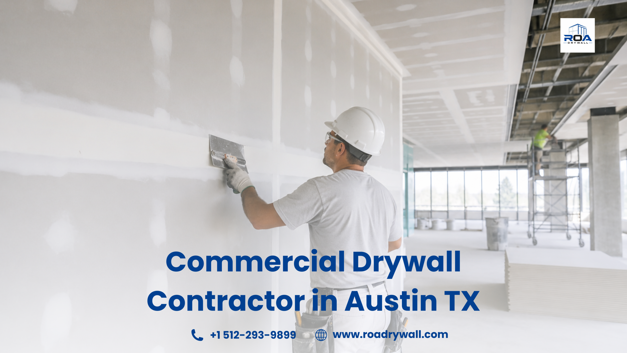 Commercial drywall contractor applying joint compound and finishing drywall seams inside a large office building under construction, with scaffolding, stacked drywall sheets, and a bright modern interior in the background.